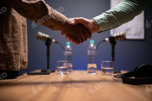 Preview: Podcasters shake hands after a good talk. Concept of podcasts and vlogs