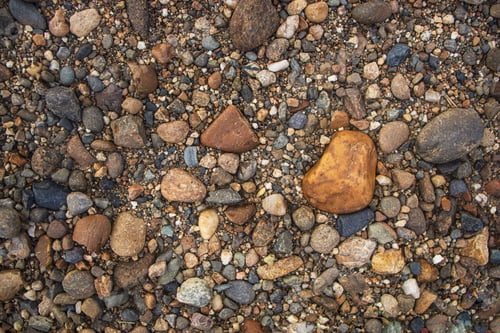 Preview: Dry land with stones.Top view of dirt road fragment, Abstract natural textured background. Stones an