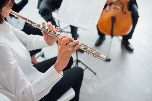 Preview: Flutist playing her instrument on stage