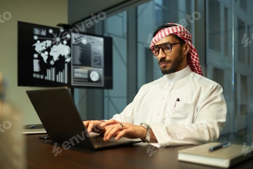 Preview: Middle Eastern Businessman Focused on Work in Office