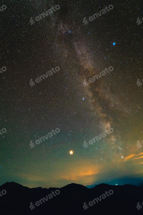 Preview: The sky with stars on the background of mountains.