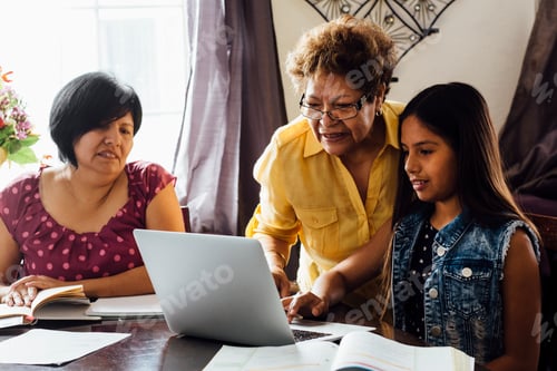 Preview: Mother and grandmother helping girl with homework using laptop