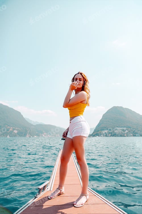 Preview: Full length of a young girl in sea against sky