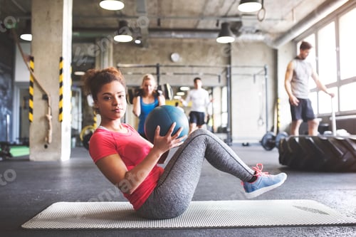 Preview: Group of young people exercising in gym