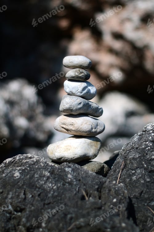 Preview: Vertical selective focus shot of six beautiful small stones lined up on each other
