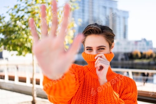 Preview: Beautiful young woman with short hair in the city