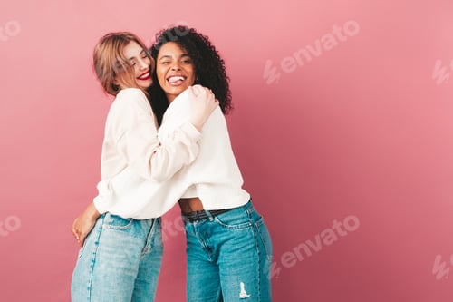 Preview: Portrait of two young funny stylish women posing in studio