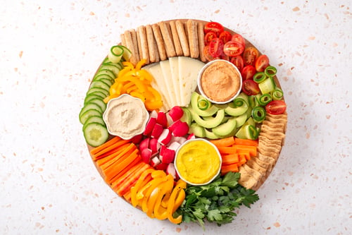 Preview: Colorful vegan Charcuterie board with raw vegetables and whole wheat snacks