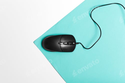Preview: Computer mouse on a turquoise paper background
