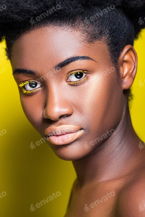 Preview: Pretty african american girl looking at camera on yellow