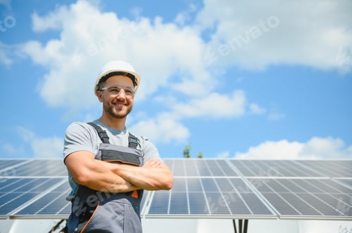 Preview: Male engineer in protective helmet installing solar photovoltaic panel system.