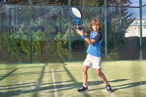 Preview: Boy playing padel on playground