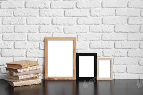 Preview: Books with picture frame on wooden table