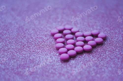 Preview: love shaped from purple pink pills. concept of medical and love