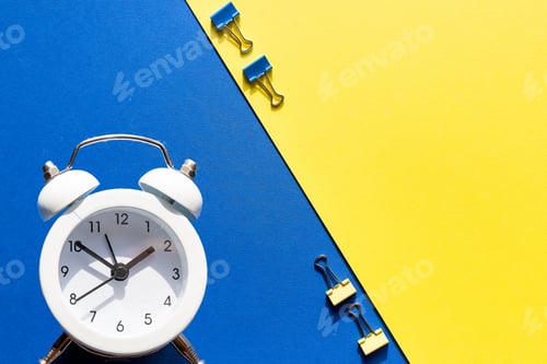 Preview: educational conceptual. clips, alarm clock and stationery against colorful background. free copy