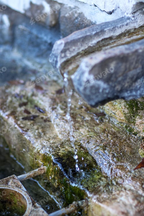 Preview: collecting safe spring mineral water from source in mountain for human consumption with glass bottle