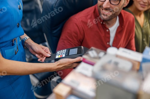 Preview: Close up shot of airline stewardess holding terminal while cheerful male passenger making payment
