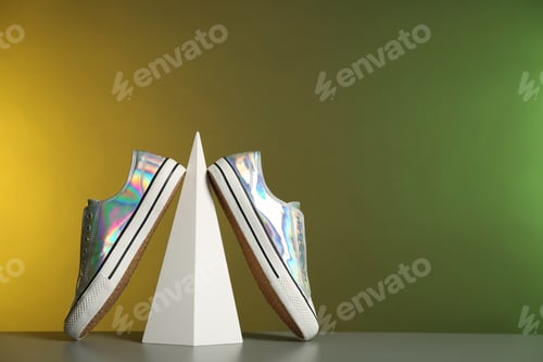 Preview: Composition with stylish shoes on table against color background. Space for text