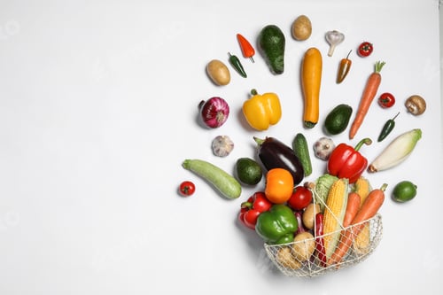 Preview: Fresh vegetables and metal basket on white background, top view