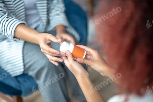 Preview: Female client taking antidepressants while visiting psychoanalysis