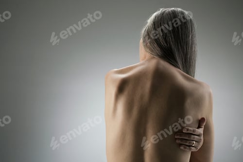Preview: Graceful silhouette of a woman with her back to the camera