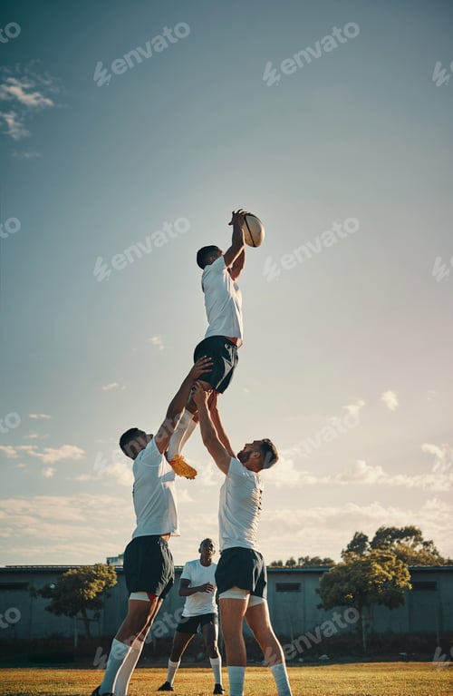 Preview: Cropped shot of a handsome young rugby player catching the ball during a lineout on the field