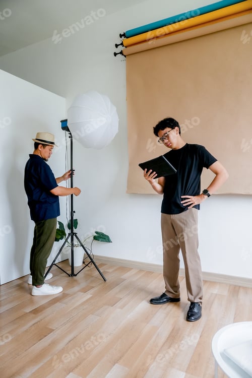 Preview: Men Preparing for Photo Shoot in Studio