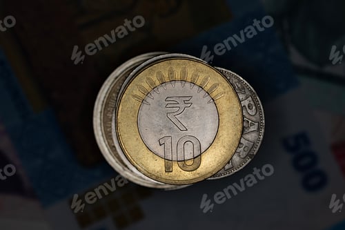 Preview: Closeup of Indian Rupee coin on a stack of a world coins