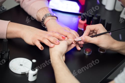 Preview: Manicurist Applying Nail Polish to Woman in Salon