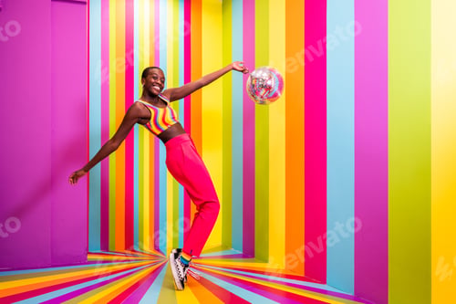 Preview: Beautiful young woman dancing and having fun inside a rainbow box room
