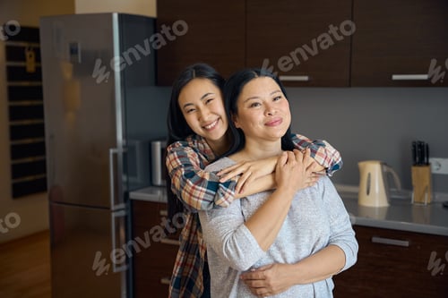 Preview: Loving daughter embracing her female parent at home