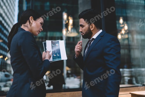 Preview: Pensive multiethnic colleagues searching for solution while discussing project in office