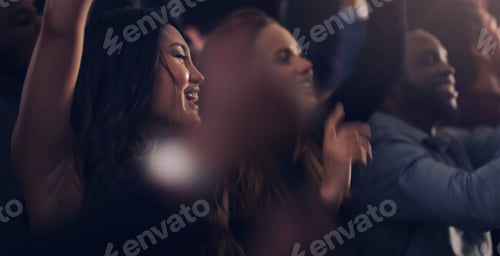 Preview: Cropped shot of a group of young friends dancing together in a nightclub