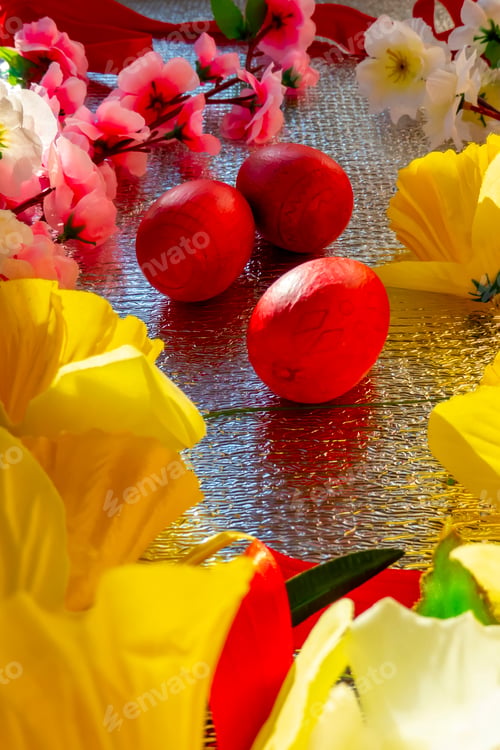 Preview: Bright Easter silver background decorated with ribbons of flowers and red eggs. A holiday card.