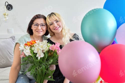 Preview: Portrait of happy smiling mom and teenage daughter, birthday celebration