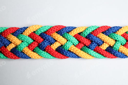 Preview: Braided colorful ropes isolated on white, top view. Unity concept