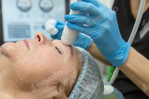 Preview: Smas lifting and rejuvenation of an elderly woman's facial skin by a cosmetologist