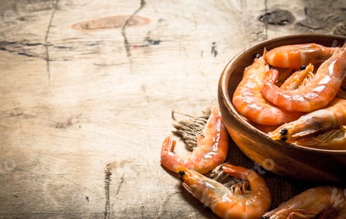 Preview: Bowl of Cooked Prawns on Rustic Wooden Surface