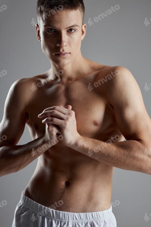 Preview: sexy athletes with inflated torso holding hands near chest on gray background cropped view