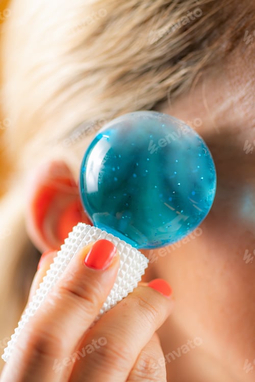 Preview: Woman Massaging her Face at Home with Ice Balls