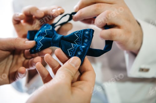 Preview: Man Adjusting Stylish Blue Bowtie Before Event