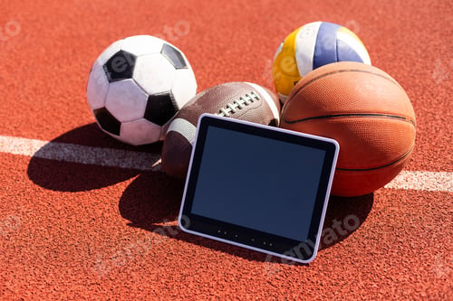 Preview: balls and tablet computer on color background. Concept of sports bet