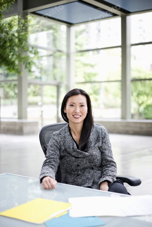 Preview: Portrait of an Asian businesswoman in the lobby of a convention center.