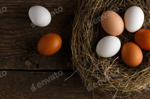 Preview: Fresh chicken eggs in a nest on a wooden background