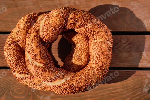 Preview: stack of freshly baked Turkish bagel simit. Wooden background. View from above.