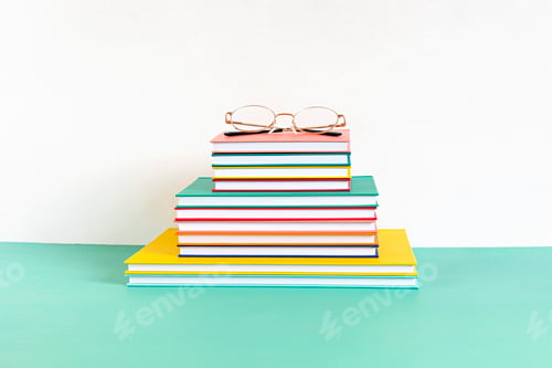 Preview: Pile of colorful books and notebooks. Education, study, learning, teaching idea