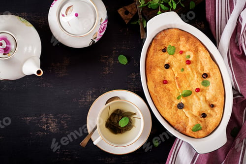 Preview: Breakfast. Appetizing cottage cheese casserole on dark table. Top view