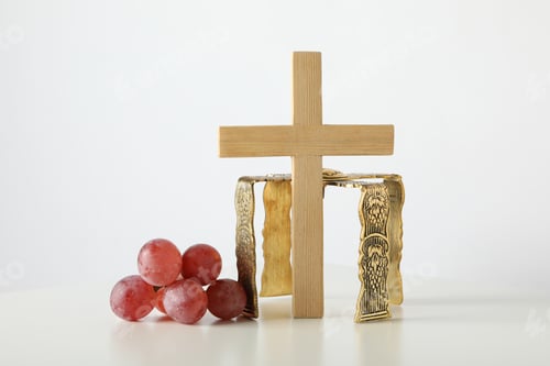 Preview: Crown of grapes and wooden cross on white background