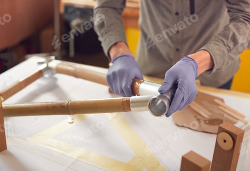 Preview: Close Up Of Male Craftsman In Workshop Assembling Hand Built Sustainable Bamboo Bicycle Frame