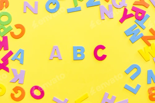 Preview: Back to school concept. Detailed plastic letters on yellow background